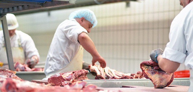 Image of catering butchers chopping up meat.